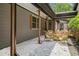 Covered patio with wicker furniture and stone landscaping for outdoor living at 2674 Skylane Dr, Marietta, GA 30062