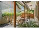 Cozy patio with wicker furniture, wooden beams, and lush landscaping offers an inviting outdoor space at 2674 Skylane Dr, Marietta, GA 30062