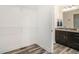 Walk-in closet with wood floor adjacent to dark-stained vanity with granite countertop at 2674 Skylane Dr, Marietta, GA 30062