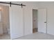 An open sliding barn door to a bathroom with a toilet and vanity at 289 White St # 3, Marietta, GA 30060