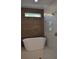 Modern bathroom with a freestanding tub and walk-in shower featuring glass enclosure and gold fixtures at 289 White St # 3, Marietta, GA 30060