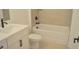 Well-lit bathroom featuring a soaking tub, tiled walls, and sleek vanity with modern fixtures at 289 White St # 3, Marietta, GA 30060