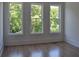 Bedroom with hardwood floors, three windows and views of mature trees at 289 White St # 3, Marietta, GA 30060