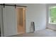 Bedroom with en suite bathroom access through sliding barn door and large window at 289 White St # 3, Marietta, GA 30060