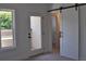 Bedroom featuring a barn door leading to a walk-in closet and an exterior deck at 289 White St # 3, Marietta, GA 30060