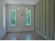 Stylish dining room with hardwood floors, olive green wall paneling, and natural light from exterior windows at 289 White St # 3, Marietta, GA 30060