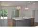 Modern kitchen with a gray island, stainless steel appliances, and large windows offering natural light at 289 White St # 3, Marietta, GA 30060