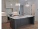 Modern kitchen with island, white backsplash, and stainless appliances at 289 White St # 3, Marietta, GA 30060