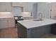 Kitchen island with white quartz countertop, stainless appliances, and globe pendants at 289 White St # 3, Marietta, GA 30060