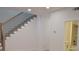 Bright staircase with dark iron railing and a view into a modernly appointed half-bathroom at 289 White St # 3, Marietta, GA 30060