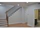 Living area showing staircase with iron railings, with an open doorway to bathroom at 289 White St # 3, Marietta, GA 30060