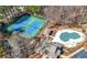 Aerial view of tennis courts and a pool, showcasing recreational amenities within the community at 3819 Trotters Run, Douglasville, GA 30135