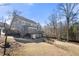 Large backyard featuring a deck, a playground, and mature trees at 3819 Trotters Run, Douglasville, GA 30135