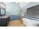 Beautiful bathroom with a soaking tub, glass shower, light blue walls, and a vanity with granite countertops at 3819 Trotters Run, Douglasville, GA 30135