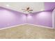 Spacious bonus room with tile floors, purple walls, and a ceiling fan at 3819 Trotters Run, Douglasville, GA 30135