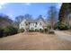 Charming two-story home featuring a well-maintained lawn, mature trees and ample parking at 3819 Trotters Run, Douglasville, GA 30135