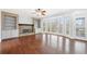 Open living room with a stone fireplace, built-in shelves, and large bay windows at 3819 Trotters Run, Douglasville, GA 30135