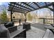 Outdoor seating area on a covered deck with a grill and view of the wooded backyard at 3819 Trotters Run, Douglasville, GA 30135