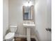 Clean half-bathroom with a pedestal sink, modern fixtures, and a neutral color palette at 4202 Morrison Way # 9, Atlanta, GA 30341