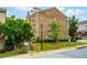 Rear view of a brick townhome with manicured lawn and shrubbery at 4202 Morrison Way # 9, Atlanta, GA 30341