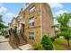 Charming brick townhome featuring a covered entryway and manicured landscaping at 4202 Morrison Way # 9, Atlanta, GA 30341