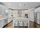 Bright kitchen boasts white cabinets, stainless steel appliances, tiled backsplash, and a spacious center island at 4202 Morrison Way # 9, Atlanta, GA 30341