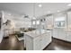 Open-concept kitchen overlooking a living room featuring a large island, stainless appliances, and ample natural light at 4202 Morrison Way # 9, Atlanta, GA 30341