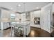 Well-lit kitchen with white cabinets, stainless steel appliances, large island, and stylish backsplash at 4202 Morrison Way # 9, Atlanta, GA 30341
