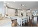 Modern kitchen with white cabinets, stainless steel appliances, center island with bar stools, and hardwood floors at 4202 Morrison Way # 9, Atlanta, GA 30341