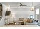 Living room view highlighting wainscotting, ceiling fan, TV, and access to the open-concept kitchen at 4202 Morrison Way # 9, Atlanta, GA 30341
