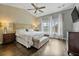 Beautiful main bedroom features a ceiling fan, dark hardwood floors, and large windows with natural light at 4202 Morrison Way # 9, Atlanta, GA 30341