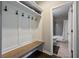 Mudroom with a wooden bench seat, shelving, and hooks leading into a bathroom area at 4202 Morrison Way # 9, Atlanta, GA 30341