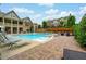 Community pool area with lots of lounge chairs and a beautiful multi story community building at 4202 Morrison Way # 9, Atlanta, GA 30341