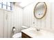 Bathroom featuring classic fixtures, wallpaper, and a framed mirror at 746 Gladstone Nw Rd, Atlanta, GA 30318
