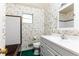 Charming bathroom with floral wallpaper, tiled shower, and vanity at 746 Gladstone Nw Rd, Atlanta, GA 30318