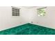 Empty bedroom featuring bright windows and unique green carpeting at 746 Gladstone Nw Rd, Atlanta, GA 30318