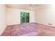 Empty bedroom with sliding glass door and pink carpet at 746 Gladstone Nw Rd, Atlanta, GA 30318