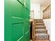 Entryway view of carpeted stairs, wood banister, and green front door at 746 Gladstone Nw Rd, Atlanta, GA 30318
