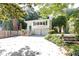 Charming white home with green shutters, lush landscaping and a large driveway at 746 Gladstone Nw Rd, Atlanta, GA 30318