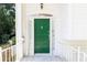 A close-up of a green front door with sidelights, hardware and white trim at 746 Gladstone Nw Rd, Atlanta, GA 30318