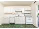 Efficient kitchen with white appliances, ample cabinetry, and green tiled floors at 746 Gladstone Nw Rd, Atlanta, GA 30318