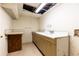 A utility room with worn cabinets, sink, and peeling walls awaits renovation beneath a damaged ceiling at 746 Gladstone Nw Rd, Atlanta, GA 30318