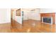 Open living room with hardwood floors, fireplace, and view into adjacent kitchen at 746 Gladstone Nw Rd, Atlanta, GA 30318