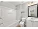 This light and bright bathroom features a tub/shower combo and a vanity with a large mirror at 1168 Liberty Nw Pkwy, Atlanta, GA 30318