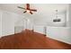 Spacious living area with hardwood floors, neutral paint and trim, and modern light fixture at 1168 Liberty Nw Pkwy, Atlanta, GA 30318