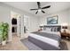 This bedroom features an en suite bathroom, a ceiling fan, closet, and gray and white decor at 1168 Liberty Nw Pkwy, Atlanta, GA 30318