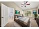 Bright main bedroom featuring a ceiling fan, artwork, a window, and an ensuite bathroom at 1168 Liberty Nw Pkwy, Atlanta, GA 30318