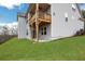 Expansive backyard featuring green lawn, covered patio, and the home's siding, ideal for outdoor enjoyment at 159 Sunshower Rdg, Canton, GA 30114