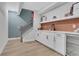 Basement bar area with sleek white cabinets, backsplash and beverage cooler at 159 Sunshower Rdg, Canton, GA 30114