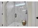 Modern bathroom shower featuring marble-patterned tile and glass door at 159 Sunshower Rdg, Canton, GA 30114
